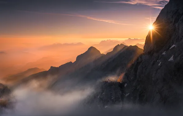 Picture the sun, light, mountains, fog, rocks, people